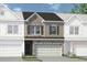 Beautiful townhouse with stone and siding exterior, a garage, and manicured landscaping at 100 Jacobs Farm Ln # 39, Lawrenceville, GA 30045