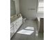 Bathroom with double vanity, bathtub, and white tile floors, perfect for relaxation at 1931 Harvest Way, Loganville, GA 30052