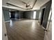 Large bedroom with wood-look floors, dark walls, recessed lighting, a ceiling fan, and ample space at 1931 Harvest Way, Loganville, GA 30052