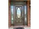 Elegant front door with glass detailing, sidelights, and a brick exterior. Includes a welcome mat at 1931 Harvest Way, Loganville, GA 30052