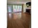 Spacious living room with hardwood floors, fireplace, and backyard access at 1931 Harvest Way, Loganville, GA 30052