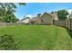 Backyard featuring green lawn and perimeter fence, offering a private outdoor space at 1553 Queen Elizabeth Dr, Locust Grove, GA 30248