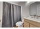 Cozy bathroom features a sleek vanity, modern mirror, and a shower with a neutral-toned curtain at 1553 Queen Elizabeth Dr, Locust Grove, GA 30248