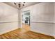 From the dining room, view the kitchen's stainless appliances and white cabinets at 1553 Queen Elizabeth Dr, Locust Grove, GA 30248