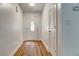 A bright entryway features a front door with an oval window and light wood flooring at 1553 Queen Elizabeth Dr, Locust Grove, GA 30248