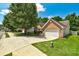 Attractive home on a large lot, featuring a brick facade, two-car garage, and a well-manicured lawn at 1553 Queen Elizabeth Dr, Locust Grove, GA 30248