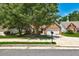 Beautiful brick home with mature trees shading the front yard and a well-kept lawn at 1553 Queen Elizabeth Dr, Locust Grove, GA 30248
