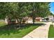 Charming brick home with a well-manicured front yard and mature trees at 1553 Queen Elizabeth Dr, Locust Grove, GA 30248