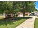 Charming brick home with a well-manicured front yard and mature trees at 1553 Queen Elizabeth Dr, Locust Grove, GA 30248