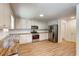 A bright kitchen features white cabinets, stainless steel appliances, and stylish butcher block countertops at 1553 Queen Elizabeth Dr, Locust Grove, GA 30248