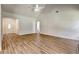 An open living space features new light wood flooring, and connects to the front door and the kitchen area at 1553 Queen Elizabeth Dr, Locust Grove, GA 30248
