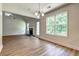 A bright living room has a fireplace and transitions to the kitchen, offering new flooring and modern fixtures at 1553 Queen Elizabeth Dr, Locust Grove, GA 30248