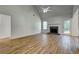 A spacious living room features a fireplace, vaulted ceilings, and new light wood flooring at 1553 Queen Elizabeth Dr, Locust Grove, GA 30248