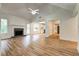 A bright living room offers a fireplace, open floorplan, and flows into the kitchen and dining area at 1553 Queen Elizabeth Dr, Locust Grove, GA 30248