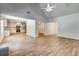 An open living space flows to the kitchen and dining areas, offering modern light fixtures and new flooring at 1553 Queen Elizabeth Dr, Locust Grove, GA 30248