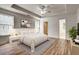 Well-lit main bedroom with tray ceilings, plush carpeting, and ample natural light at 1553 Queen Elizabeth Dr, Locust Grove, GA 30248