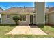Back of house featuring a patio, door to backyard, and green lawn at 1553 Queen Elizabeth Dr, Locust Grove, GA 30248