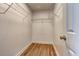 Neat walk-in closet with wire shelves for clothing and accessory storage at 1553 Queen Elizabeth Dr, Locust Grove, GA 30248