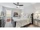 Bright bedroom featuring a ceiling fan and a cozy bed with decorative pillows, creating a serene atmosphere at 3115 Seven Pines Ct # 308, Atlanta, GA 30339