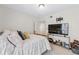 Cozy bedroom featuring a gold bed frame, TV, and warm lighting at 3115 Seven Pines Ct # 308, Atlanta, GA 30339