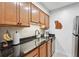 Well-lit kitchen featuring granite countertops, stainless steel appliances, and ample wooden cabinetry at 3115 Seven Pines Ct # 308, Atlanta, GA 30339