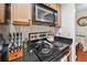 Galley kitchen with a black cooktop, stainless steel microwave, and adjacent breakfast table at 3115 Seven Pines Ct # 308, Atlanta, GA 30339