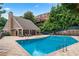 Community pool with lounge chairs and surrounding landscaping at 3115 Seven Pines Ct # 308, Atlanta, GA 30339