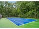 Well-maintained blue and green community tennis court surrounded by trees at 3115 Seven Pines Ct # 308, Atlanta, GA 30339