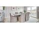 Elegant dining area with a table for six, complemented by stylish decor and ample natural light at 404 Satilla Ct, Locust Grove, GA 30248