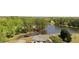 Aerial view of the sprawling property featuring a picturesque lake and lush tree coverage at 794 Rutland Ct, Lithonia, GA 30058