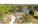 Aerial view showing the home, detached garage, circular drive, and proximity to the lake at 794 Rutland Ct, Lithonia, GA 30058
