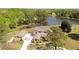 Aerial view of a lakeside home featuring a long driveway and beautiful landscaping at 794 Rutland Ct, Lithonia, GA 30058