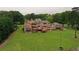 A view of the rear of the property, which features a large deck and manicured lawn at 794 Rutland Ct, Lithonia, GA 30058