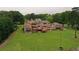 Expansive backyard featuring a manicured lawn, mature trees, and multi-level decking, perfect for outdoor gatherings at 794 Rutland Ct, Lithonia, GA 30058