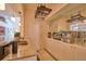 Granite bar featuring pendant lighting, wine racks, glassware storage and mirror at 794 Rutland Ct, Lithonia, GA 30058