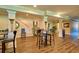 Spacious basement with classic columns, warm wood flooring, and bar seating creates a welcoming atmosphere at 794 Rutland Ct, Lithonia, GA 30058