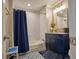 Charming bathroom featuring subway tile, a blue vanity, and decorative patterned flooring, creating a cozy space at 794 Rutland Ct, Lithonia, GA 30058
