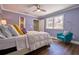 Bedroom with blue walls and a comfortable bed, chair, and hardwood floors at 794 Rutland Ct, Lithonia, GA 30058