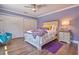 Bedroom featuring hardwood floors, a ceiling fan, and bright natural light from the exterior window at 794 Rutland Ct, Lithonia, GA 30058