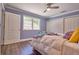 Bedroom featuring hardwood floors, a ceiling fan, and bright natural light from the exterior window at 794 Rutland Ct, Lithonia, GA 30058