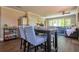 Dining area with table and chairs, stainless steel refrigerator and view into living room at 794 Rutland Ct, Lithonia, GA 30058