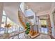 Bright foyer with a curved staircase and large windows bringing in natural light at 794 Rutland Ct, Lithonia, GA 30058