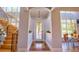 Inviting entryway with a spiral staircase and a view to the dining area with large windows at 794 Rutland Ct, Lithonia, GA 30058
