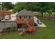 Exterior elevation of a brick home with a detached structure and a wooden deck at 794 Rutland Ct, Lithonia, GA 30058