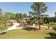 Expansive lawn and mature landscaping lead to a two-story brick home with a detached garage at 794 Rutland Ct, Lithonia, GA 30058