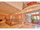 Grand foyer with columns, staircase, and view into living room with ample natural light at 794 Rutland Ct, Lithonia, GA 30058