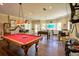 Spacious game room with a pool table, foosball table, and seating area perfect for entertaining guests at 794 Rutland Ct, Lithonia, GA 30058