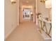 Long, carpeted hallway featuring stylish lighting and a console table with marble top at 794 Rutland Ct, Lithonia, GA 30058