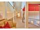 Bright second-story hallway featuring carpet floors, wood railings, natural light, and a cozy seating area at 794 Rutland Ct, Lithonia, GA 30058