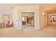 Spacious hallway offers a view to a well-lit office with built-in shelving and neutral carpeting at 794 Rutland Ct, Lithonia, GA 30058